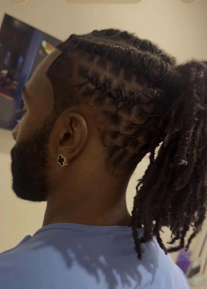 Locs with a clean taper and lineup at Bud Kutz